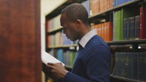 Man holding a book in the library